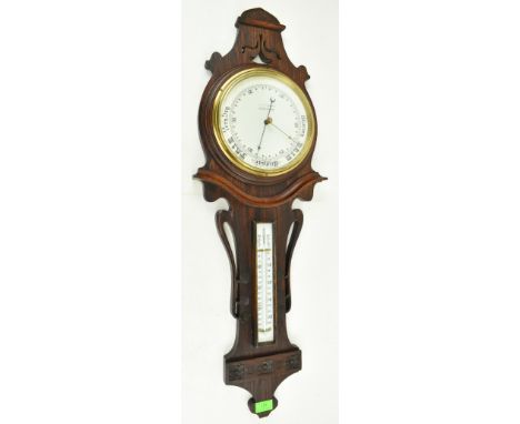An early 20th century Art Nouveau mahogany cased banjo wall barometer &amp; thermometer. The barometer with carved foliate No