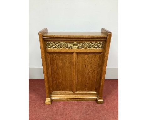 A XX Century Oak Book Stand, with a slightly sloping top and frieze with gilt winged angel and scroll decoration, side suppor