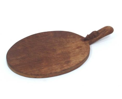 A Robert Thompson 'Mouseman' Oak Cheese Board, with short handle carved with mouse trademark, 37cm long.