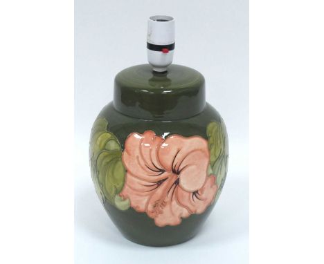 A Moorcroft Pottery Table Lamp, painted in the 'Coral Hibiscus' pattern against a green ground, impressed marks, with shade, 