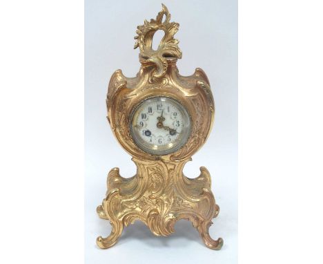 A Late XIX Century French Mantle Clock, the ornate ormolu case cast with scrollwork and flowers, the circular white enamel di