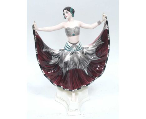 A Goldscheider Pottery Figure of a Dancer, wearing a grey and green bikini top and patterned grey, maroon and green skirt, sh