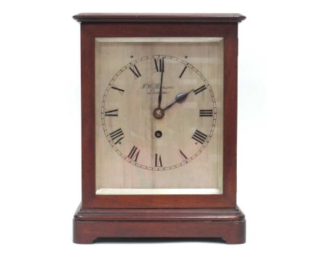 An Early XX Century Mahogany Cased Mantle Clock, of plain form raised on a stepped base, the sides with glass panels and bras