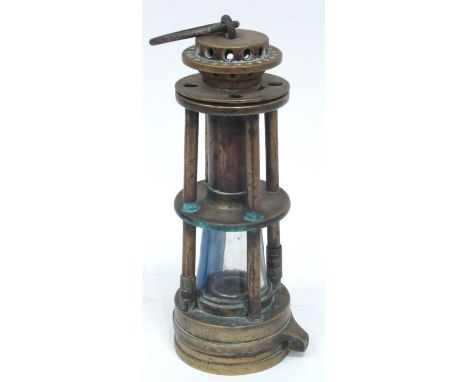 A Davis of Derby Brass Gray Miners Safety Lamp, each level with four columns, iron carrying loop, 24c high.MAKERS NAME IS THE