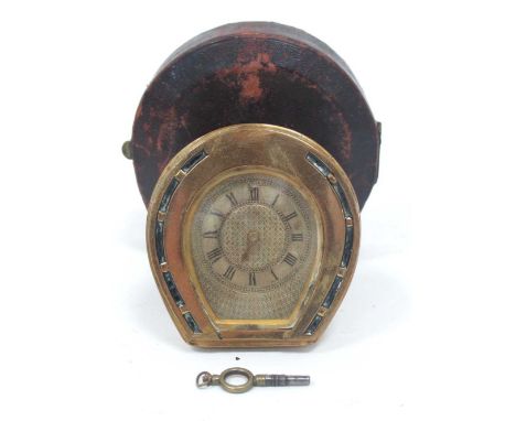 A Late XIX Century Travelling Brass Cased Clock, of horseshoe shape, easel back and Roman numerals to chapter ring, key prese