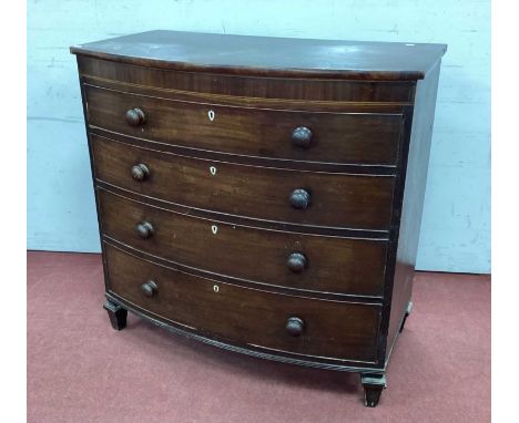 An Early XIX Century Mahogany Bow Fronted Chest of Drawers, with four drawers on tapering block supports, 108cm high, 109cm w