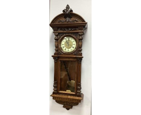 A Late XIX Century Mahogany Cased Vienna Wall Clock, with two weights, the cream enamel dial with Roman numerals, the case of