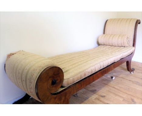 Regency mahogany scroll end chaise longue or day bed in the Egyptian style, on scroll supports with brass claw caps and ceram