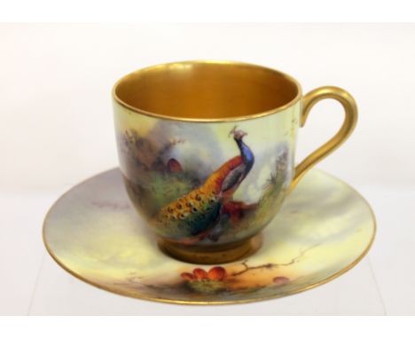 Royal Worcester coffee cup & saucer with hand painted decoration of a peacock in a fir tree, by Reginald Harry Austin, cup & 