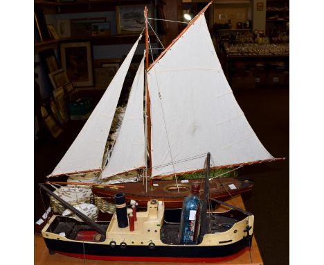 A 20th century model pond yacht on stand; together with a wooden model of a ship and a ship in a bottle; together with toys i