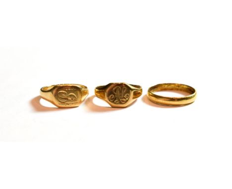 Two 9 carat gold signet rings, finger sizes J and K; and an 18 carat gold band ring, finger size L.  Two 9 carat gold rings -