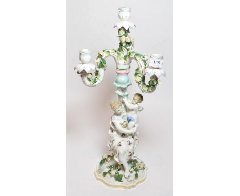 A German porcelain floral encrusted four light candelabra 