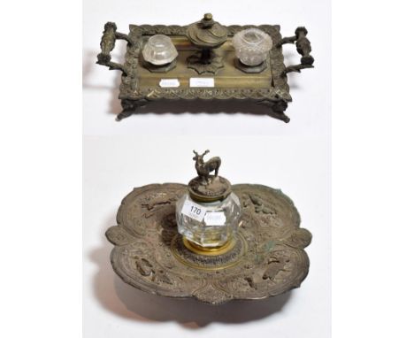 A large 19th century silver plated repousee deskstand, in the manner of Elkington, the glass inkwell surmounted by a stag; to