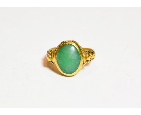 A jade type ring, finger size T.  The surface is scuffed. It is indistinctly marked with Chinese symbols. Gross weight 12.5 g