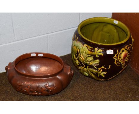 A Bretby Art Pottery jardiniere, decorated with dragons and the flaming pearl, in greens, yellow and brown, impressed factory