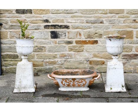 A Pair of Victorian White Painted Cast Iron Garden Urns, moulded with stiff leaves on flared square section columns, 70cm hig