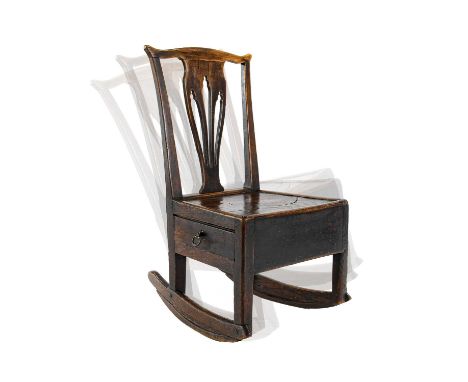 A 19th Century Ash and Elm Lambing Rocking Chair, the comb shaped top rail above a pierced splat and moulded seat with frieze