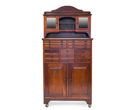 A Late Victorian Mahogany Dentist's Cabinet, circa 1900, the upper section with three-quarter gallery above an open niche wit