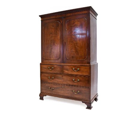 A George III Mahogany Linen Press, late 18th century, the dentil cornice above a plain frieze and moulded cupboard doors encl