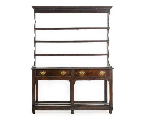 A George III Oak Potboard Dresser and Rack, 3rd quarter 18th century, the upper section with a moulded cornice above three op
