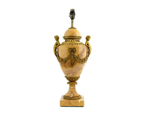 A Gilt Metal Mounted Marble Lamp Base, in Louis XVI style, of urn form with twin figural handles hung with fruit and flower s