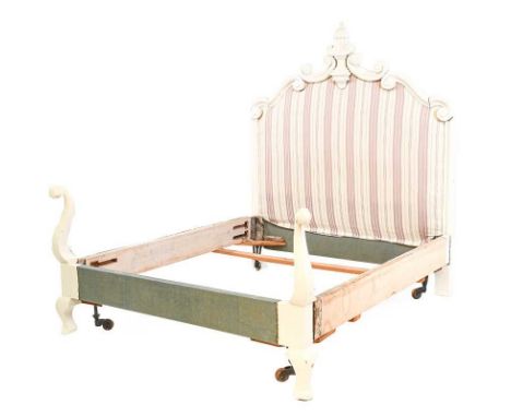 ~ A 19th Century White Painted Deal Double Bedstead, the cartouche shaped headboard upholstered in floral striped fabric and 