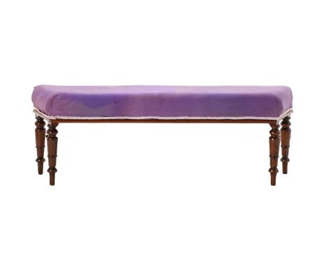 A Victorian Mahogany Window Seat, 3rd quarter 19th century, recovered in purple cotton fabric, the canted rectangular overstu