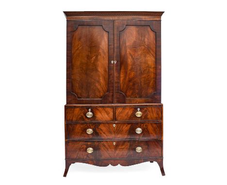 A George III Mahogany Linen Press, circa 1800, the dentil cornice above moulded cupboard doors enclosing converted hanging sp