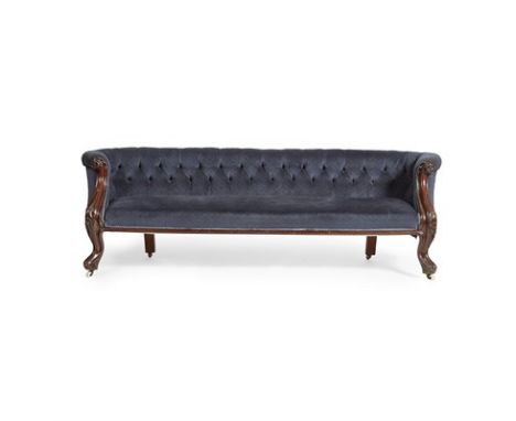 VICTORIAN MAHOGANY FRAMED SOFA MID-19TH CENTURY the low button-upholstered back and curved arms with foliate scroll carved fa