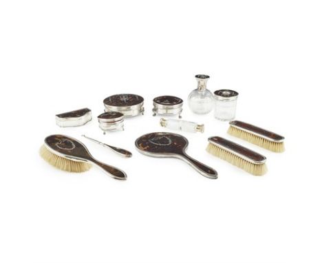 Y MATCHED TEN PIECE SILVER-MOUNTED TORTOISESHELL DRESSING SET 20TH CENTURY with various patterns, comprising a hair brush, 25