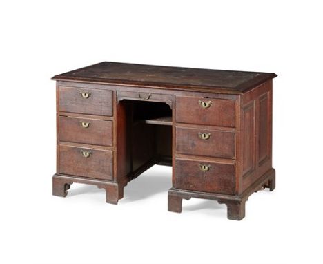 GEORGE II OAK PEDESTAL DESK SECOND QUARTER 18TH CENTURY the moulded top with a leather insert, above a shallow drawer and arc