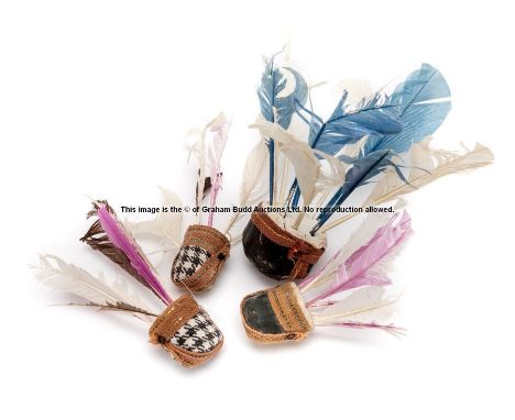 Four vintage feathered badminton shuttlecocks, each of varying size with coloured feathers, largest 12cm.