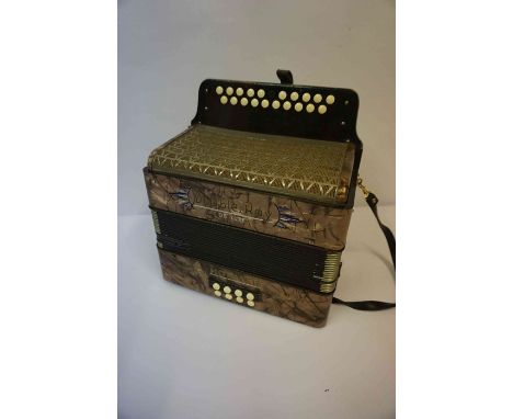 A Hohner Double Ray De-Luxe Accordion, with carry strap, 34cm high
