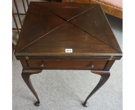 A Mahogany Envelope Card Table, circa early 20th century, Having a revolving top, enclosing a green felt interior and gaming 