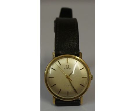 An Omega Gents 9ct Gold Geneve Wristwatch, circa 1950s, 60s, Having manual wind, baton markers, black leather strap with orig