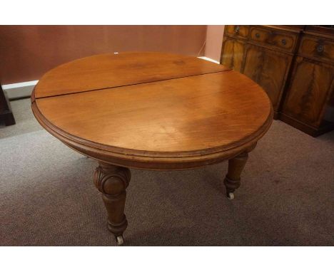 A Victorian Mahogany D End Extending Dining Table, Having one additional leaf, raised on carved baluster legs with ceramic ca