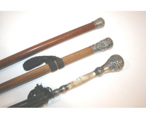 WALKING STICKS including a silver top walking stick with malacca shaft, another walking stick with decorative mount, and para