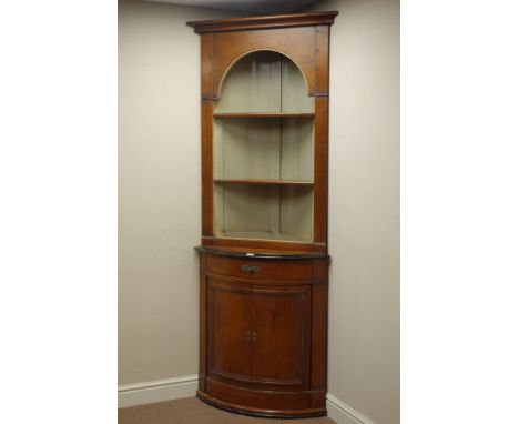 French Empire style cherry wood bow front corner cabinet, barrel back with two adjustable shelves, above drawer and double cu