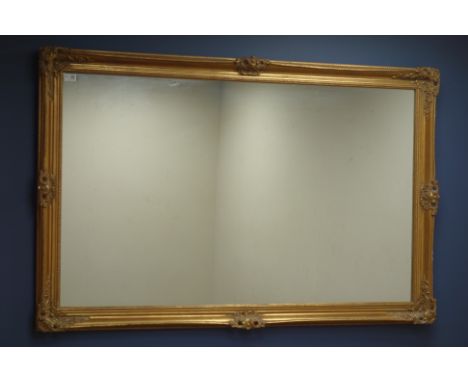 Large wall mirror in ornate swept gilt frame, 91cm x 142cm   Condition Report   Click here for further images, condition, auc