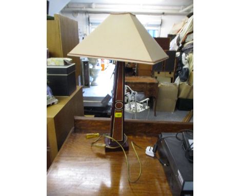 A maroon square lamp with shade 