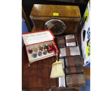 A mid 20th century walnut cased mantel clock with a cased brush set and vintage dyes 