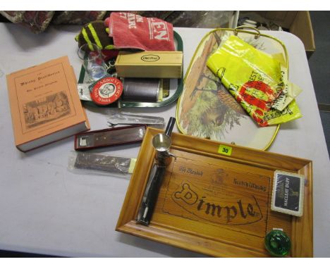 An assortment of Scotch Whisky memorabilia to include a wood picture, bar towels and a book on the Whisky Distilleries 