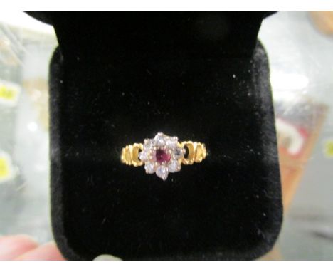 An 18ct yellow gold, diamond and ruby flower head cluster ring 