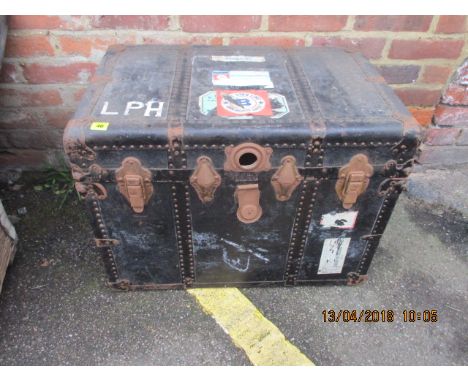 A vintage black painted trunk with leather corners 