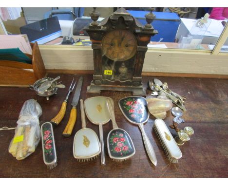 A selection of mixed flatware, a shell, a wooden cased mantle clock and a dressing table brush set 