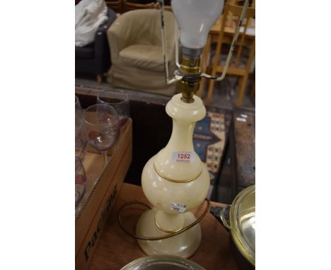 A turned alabaster table lamp, with gilt embellishments, lacking shade