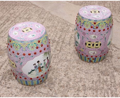 A pair of Chinese polychrome enamel decorated drum-shaped garden seats with figured panels, 19" high 