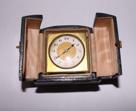 A gilt metal cased Zenith travelling alarm clock with silvered and gilt dial and Arabic numerals, in fitted case 