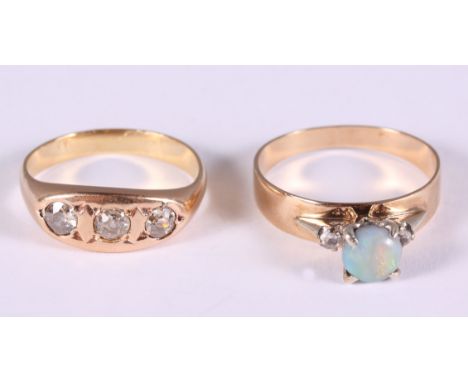 A gold, diamond and opal dress ring, size P, and a gold and diamond three stone gypsy ring, size M 