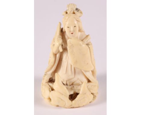 A late 19th Century Japanese carved ivory netsuke, formed as a geisha and oni, signed to the base, 2" high 